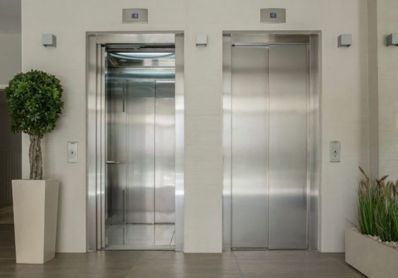 Two elevator doors, one is open and one is closed.