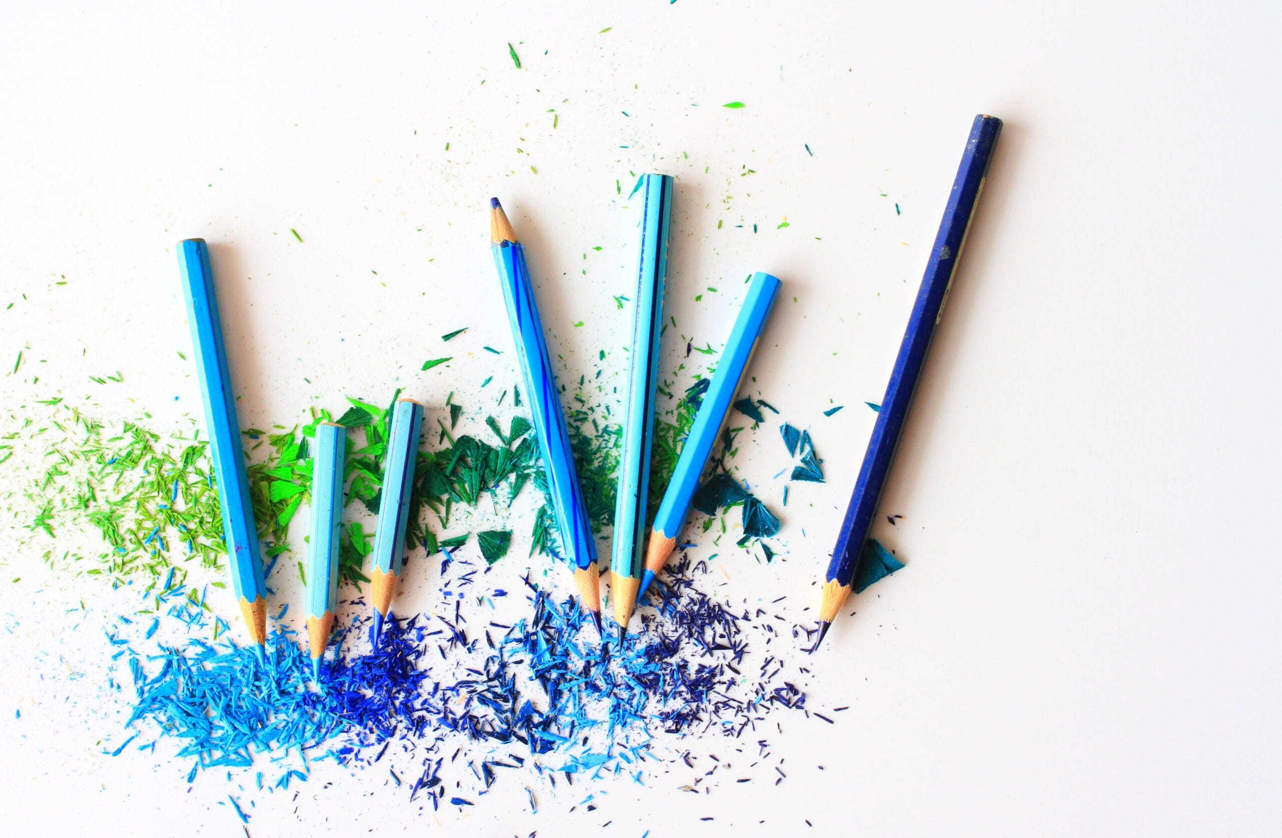 Blue and green pencil crayons and pencil crayon shavings.