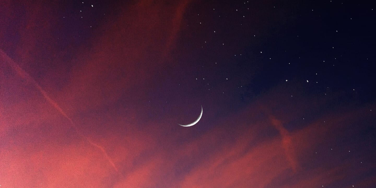 Crescent moon in starry sky.
