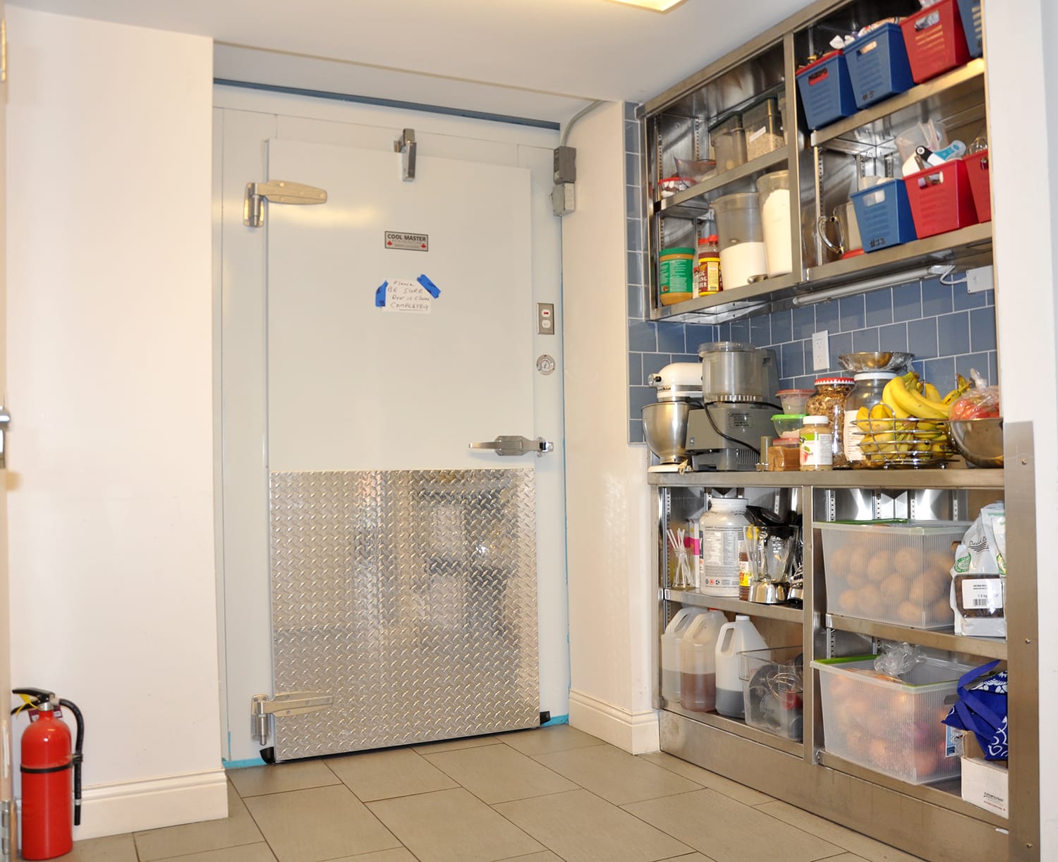 Kitchen storage and cooler door at Renascent Treatment Centre.