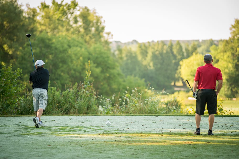 Two people on golf course.