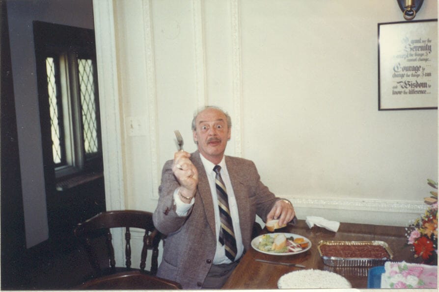 Bert Thompson sitting at table and eating.