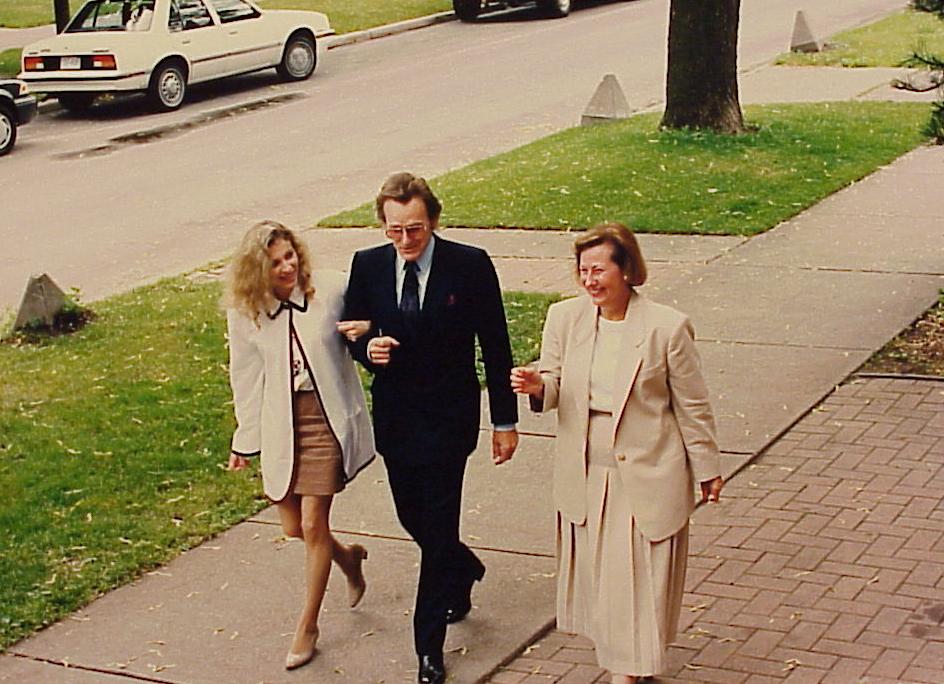 Three people walking on sidewalk to Madison Open.