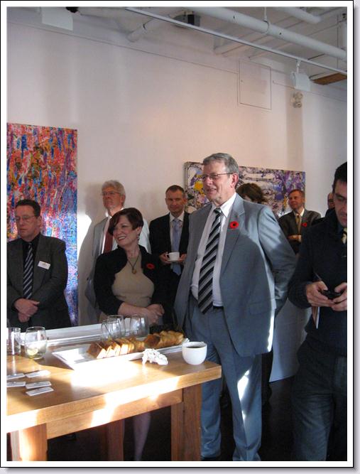 Les Talbot standing with people around him at retirement party.