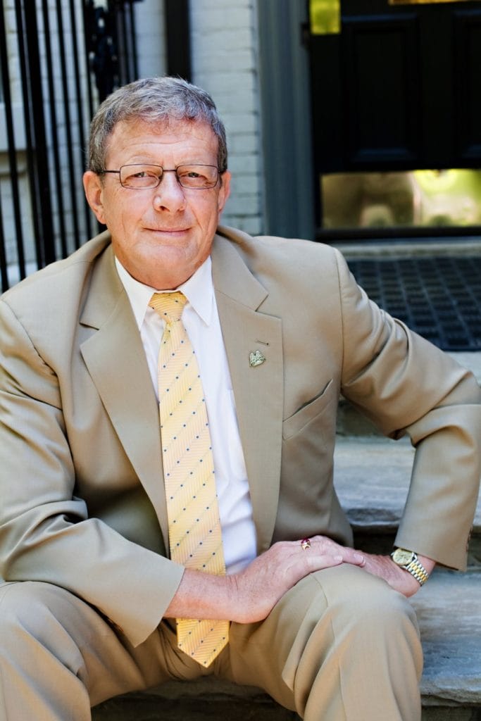 Les Talbot sitting on stairs in front of Wright Centre