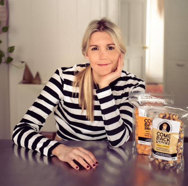 Emily O'Brien poses with bags of gourmet popcorn