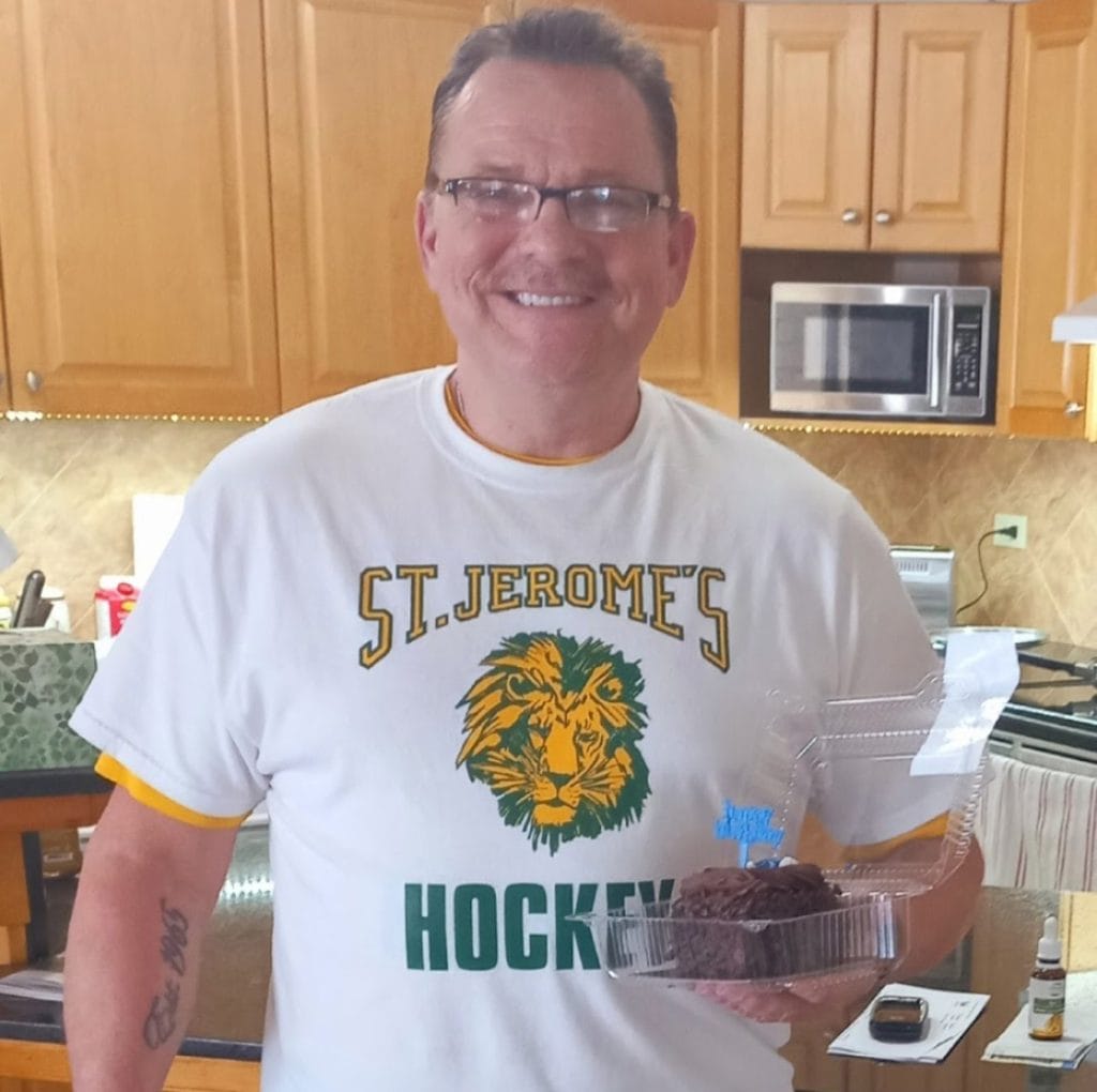 Kevin holding a slice of cake.