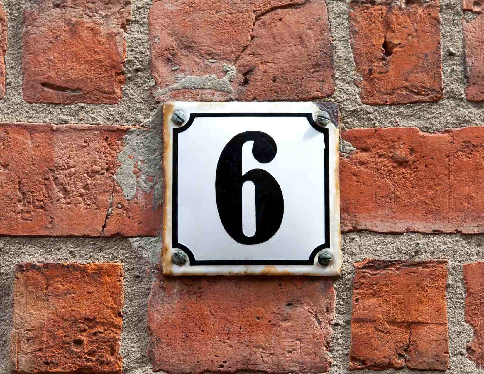 The number 6 inset in bricks.