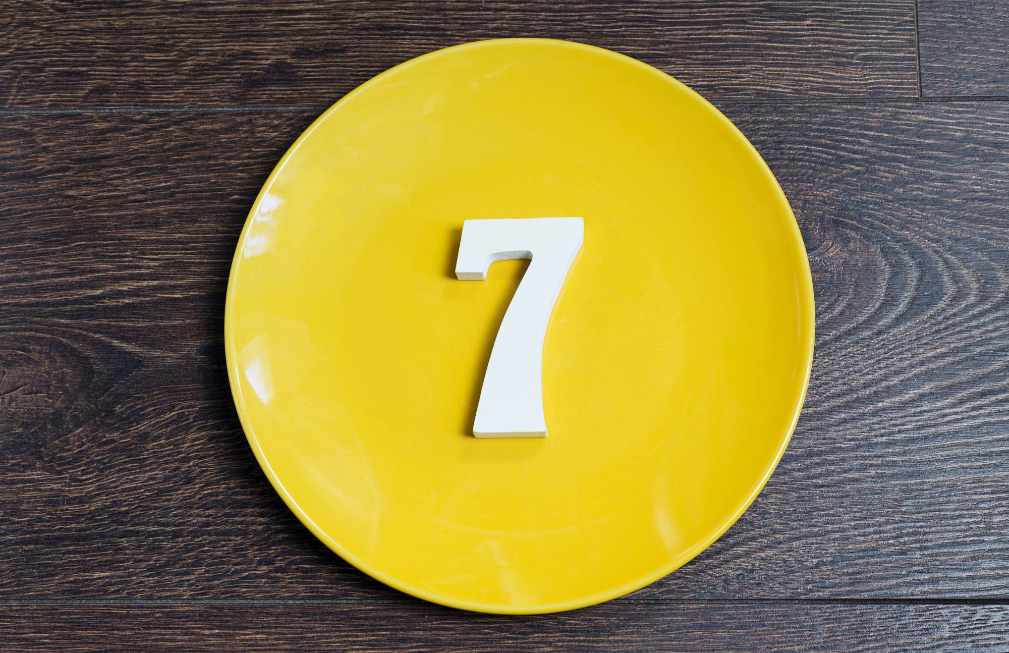 The number 7 in a yellow circle.